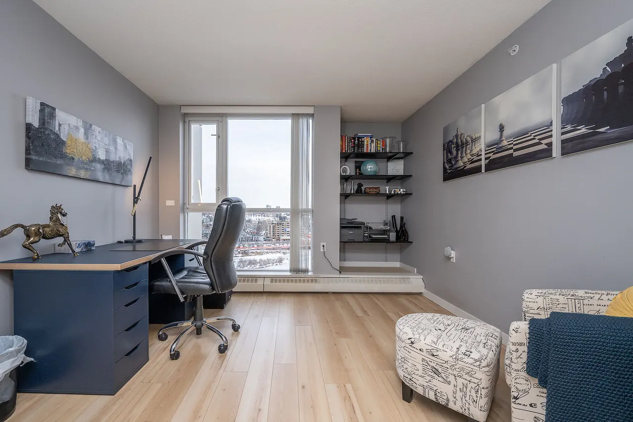 Den set up as an office, with a desk by the window