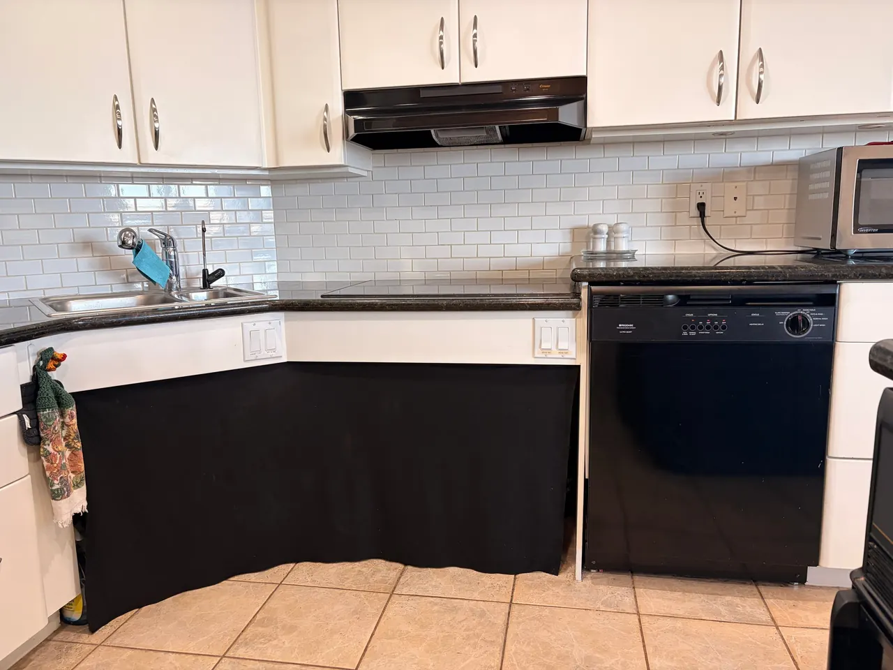 Lowered kitchen sink counter beside the dishwasher, with knee space behind a fabric skirt